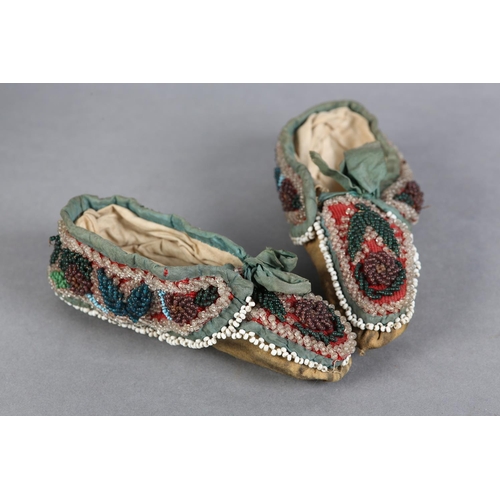 69 - A PAIR OF MID 19TH CENTURY CHILD'S BEADED SLIPPERS, worked in turquoise, teal, aubergine, green and ... 