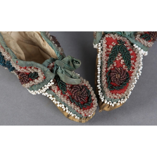 69 - A PAIR OF MID 19TH CENTURY CHILD'S BEADED SLIPPERS, worked in turquoise, teal, aubergine, green and ... 