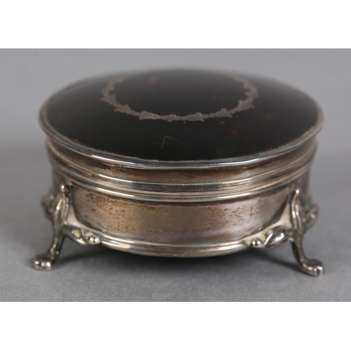 197 - A LATE 19TH CENTURY TORTOISESHELL AND SILVER JEWELLERY BOX, Birmingham 1922, circular with silk line... 