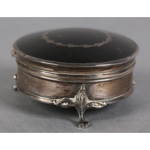 197 - A LATE 19TH CENTURY TORTOISESHELL AND SILVER JEWELLERY BOX, Birmingham 1922, circular with silk line... 