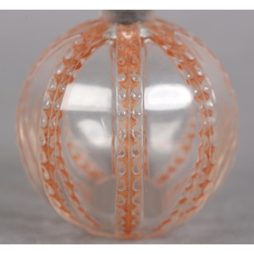 200 - A FRENCH ART DECO SPHERICAL GLASS SCENT BOTTLE, the clear glass body moulded with coral stained vert... 