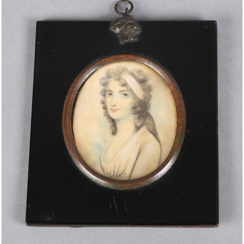 187 - AN EARLY 19TH CENTURY PORTRAIT MINIATURE OF A YOUNG LADY, in Regency dress, her hair caught in a pal... 