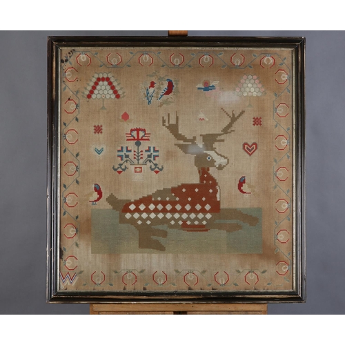 72 - A MID 19TH CENTURY NEEDLEWORK PANEL worked in red, blue, ivory, camel and fox red wools with a recum... 