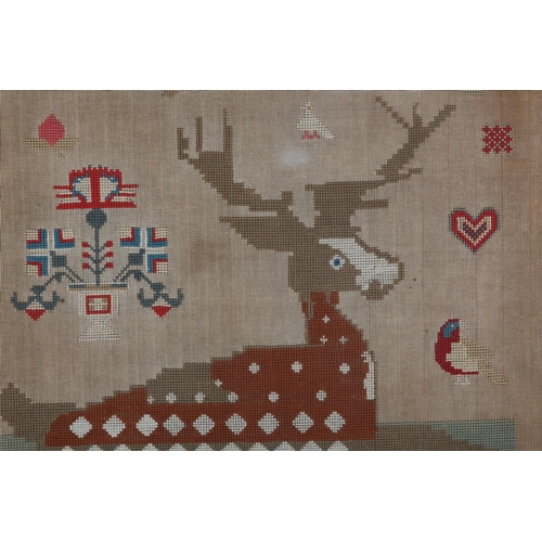 72 - A MID 19TH CENTURY NEEDLEWORK PANEL worked in red, blue, ivory, camel and fox red wools with a recum... 