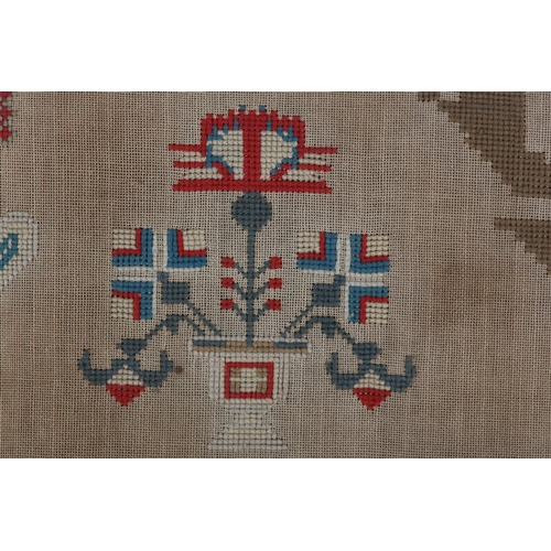 72 - A MID 19TH CENTURY NEEDLEWORK PANEL worked in red, blue, ivory, camel and fox red wools with a recum... 