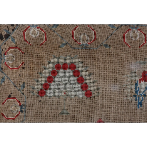 72 - A MID 19TH CENTURY NEEDLEWORK PANEL worked in red, blue, ivory, camel and fox red wools with a recum... 