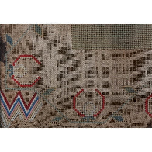 72 - A MID 19TH CENTURY NEEDLEWORK PANEL worked in red, blue, ivory, camel and fox red wools with a recum... 