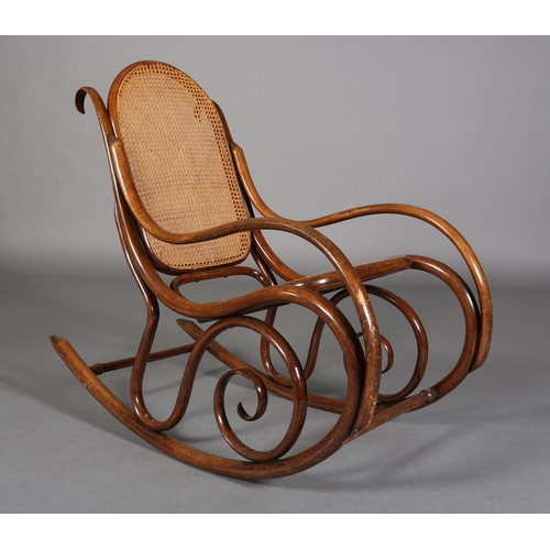 325 - A LATE 19TH CENTURY THONET BENTWOOD ROCKING CHAIR with bergere cane back and seat