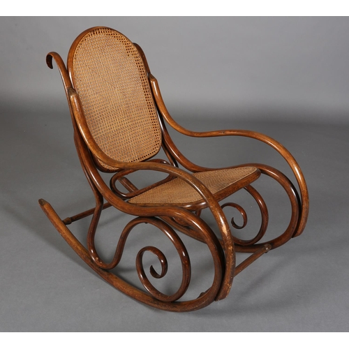 325 - A LATE 19TH CENTURY THONET BENTWOOD ROCKING CHAIR with bergere cane back and seat