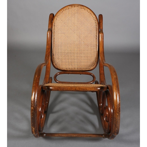 325 - A LATE 19TH CENTURY THONET BENTWOOD ROCKING CHAIR with bergere cane back and seat