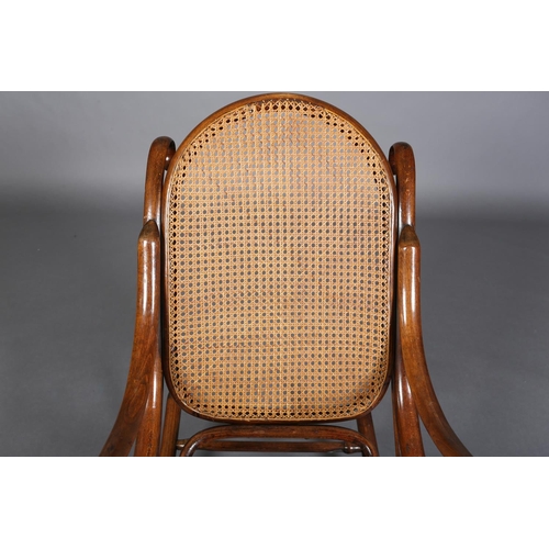 325 - A LATE 19TH CENTURY THONET BENTWOOD ROCKING CHAIR with bergere cane back and seat