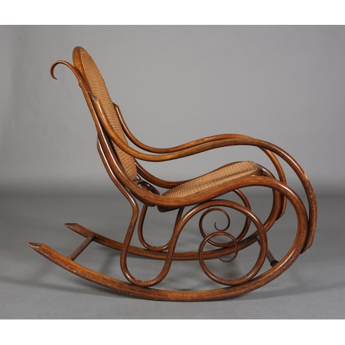 325 - A LATE 19TH CENTURY THONET BENTWOOD ROCKING CHAIR with bergere cane back and seat