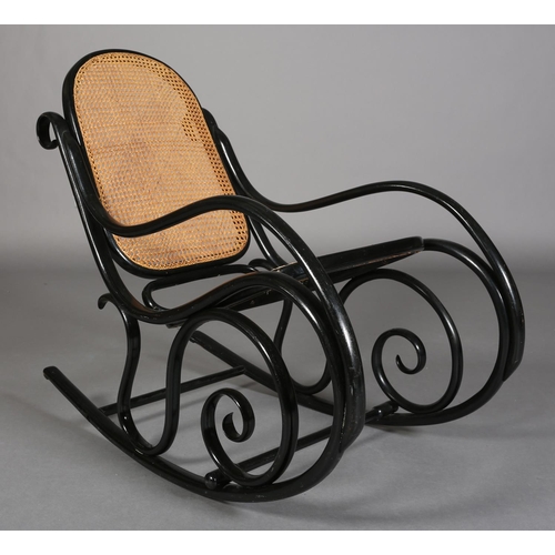 326 - A LATE 19TH CENTURY THONET EBONISED BENTWOOD ROCKING CHAIR with bergere cane back and seat