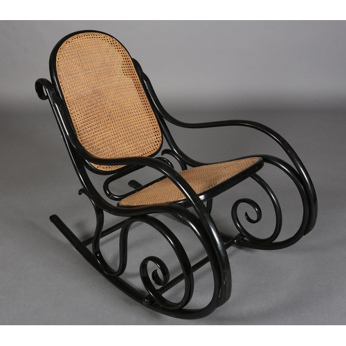 326 - A LATE 19TH CENTURY THONET EBONISED BENTWOOD ROCKING CHAIR with bergere cane back and seat