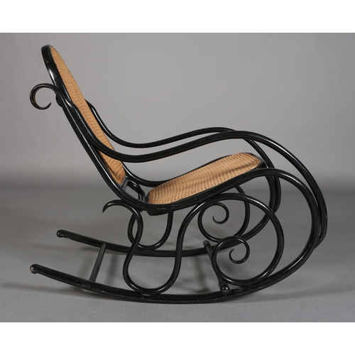 326 - A LATE 19TH CENTURY THONET EBONISED BENTWOOD ROCKING CHAIR with bergere cane back and seat