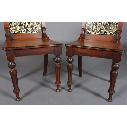 317 - A PAIR OF LATE 19TH CENTURY WALNUT HALL CHAIRS, the arched backs inset with tiles from the Minton Ea... 