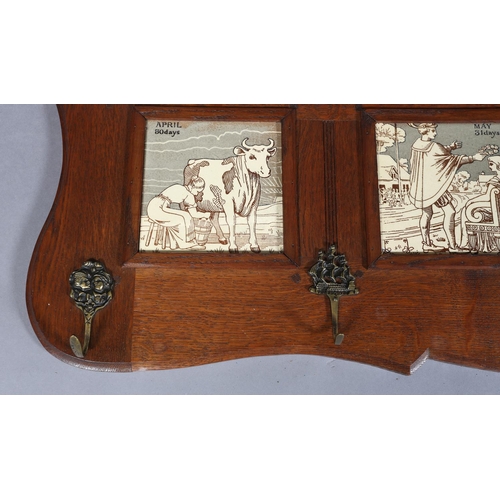 323 - A LATE 19TH CENTURY OAK HALL RACK inset with four tiles representing the months of April 30 days, Ma... 