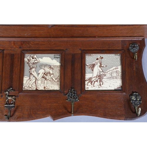 323 - A LATE 19TH CENTURY OAK HALL RACK inset with four tiles representing the months of April 30 days, Ma... 