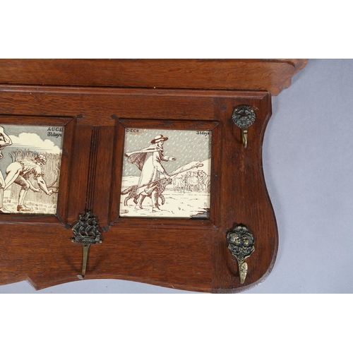 323 - A LATE 19TH CENTURY OAK HALL RACK inset with four tiles representing the months of April 30 days, Ma... 