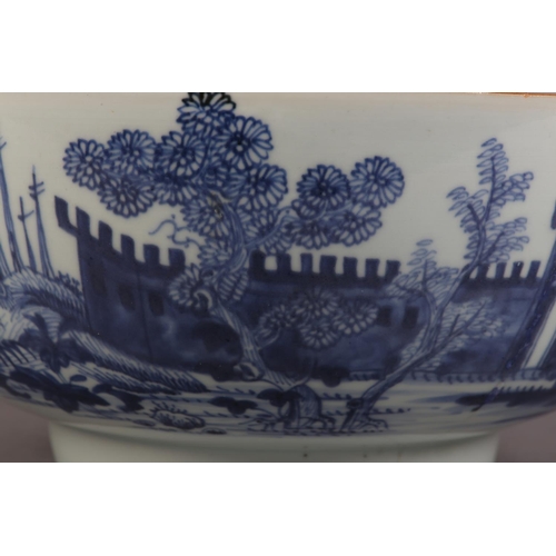 175 - AN 18TH CENTURY CHINESE BLUE AND WHITE BOWL, painted to the exterior with a fort and landscape crane... 