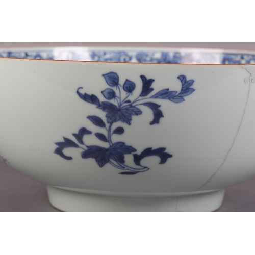 175 - AN 18TH CENTURY CHINESE BLUE AND WHITE BOWL, painted to the exterior with a fort and landscape crane... 