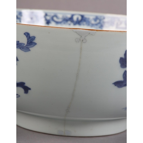 175 - AN 18TH CENTURY CHINESE BLUE AND WHITE BOWL, painted to the exterior with a fort and landscape crane... 