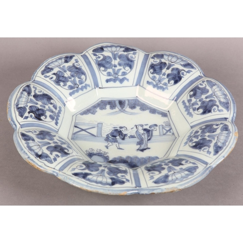 160 - AN 18TH CENTURY DUTCH DELFT LOBED DISH, painted in the chinoiserie manner with an elegant figure and... 