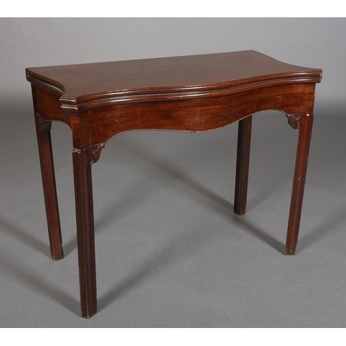 343 - AN 18TH CENTURY MAHOGANY CARD TABLE of serpentine outline, the fold-over top lined in baise, above a... 