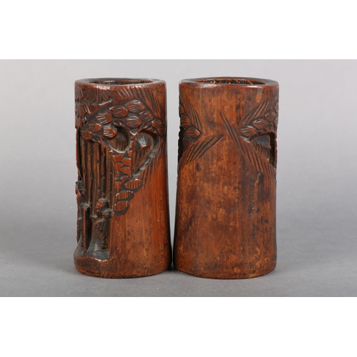 176 - A PAIR OF 19TH CENTURY BAMBOO BRUSH POTS, each carved in relief with figures amongst trees beneath a... 