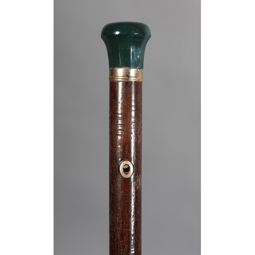 111 - A LATE 19TH CENTURY HARDSTONE TOPPED WALKING CANE, the faceted and turn bloodstone top set in a 9ct ... 