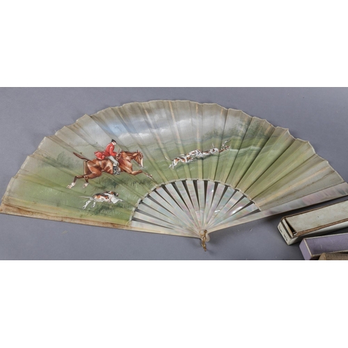 13 - A large late 19th century mother of pearl/burgau fan, boxed, the white gauze leaf painted with a hun... 