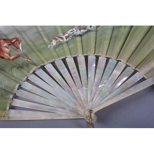 13 - A large late 19th century mother of pearl/burgau fan, boxed, the white gauze leaf painted with a hun... 