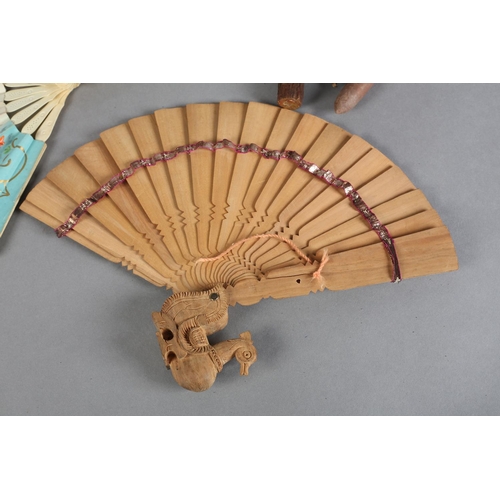 17 - Novelty fans: a mid-19th century bone telescopic fan, the double paper leaf lithographed in fresh co... 