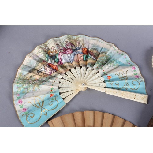 17 - Novelty fans: a mid-19th century bone telescopic fan, the double paper leaf lithographed in fresh co... 