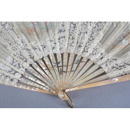 24 - Cherubs at Play: a large late 19th century Brussels bobbin lace fan, the leaf with a central gauze c... 