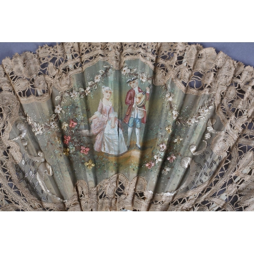 25 - A smaller lace fan, Brussels bobbin lace, with unusually with embroidery to the gauze leaf, a lady i... 