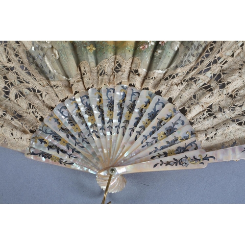 25 - A smaller lace fan, Brussels bobbin lace, with unusually with embroidery to the gauze leaf, a lady i... 