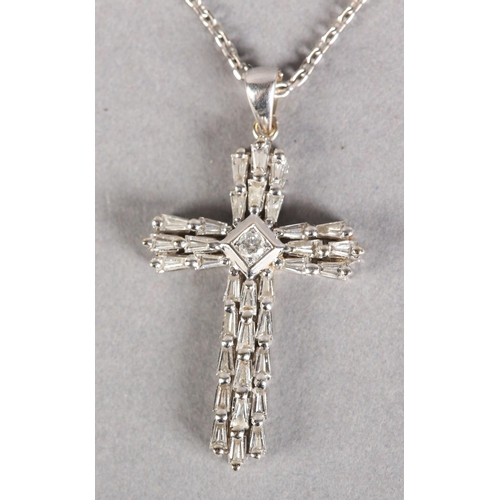 253 - A DIAMOND SET CROSS SET with tapered baggett cut stones with a single brilliant cut stone to the cen... 