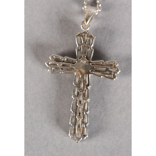 253 - A DIAMOND SET CROSS SET with tapered baggett cut stones with a single brilliant cut stone to the cen... 