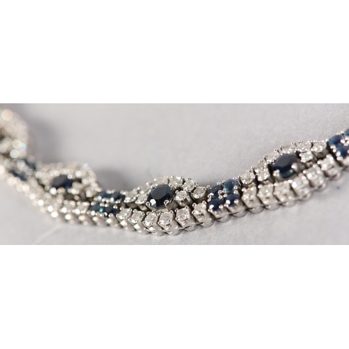 254 - A SAPPHIRE AND DIAMOND BRACELET, claw set with brilliant cut diamonds and circular faceted sapphires... 