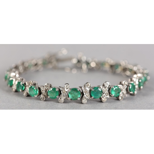 255 - AN EMERALD AND DIAMOND BRACELET, the circular faceted emeralds claw set in line, interspersed with a... 