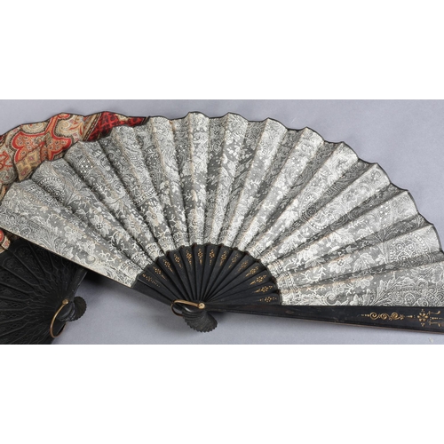 26 - C 1880's, two fans with black wood montures, the first mounted with a fabric leaf printed in the sty... 