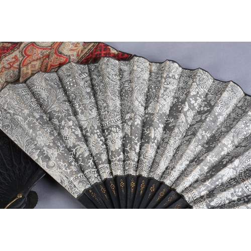 26 - C 1880's, two fans with black wood montures, the first mounted with a fabric leaf printed in the sty... 