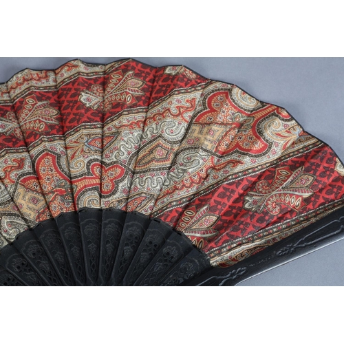 26 - C 1880's, two fans with black wood montures, the first mounted with a fabric leaf printed in the sty... 