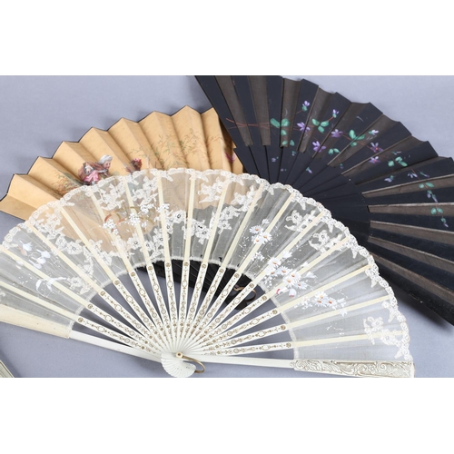 31 - Seven large late 19th century folding fans: an elegant wood fan, the monture gilded, the strong blac... 