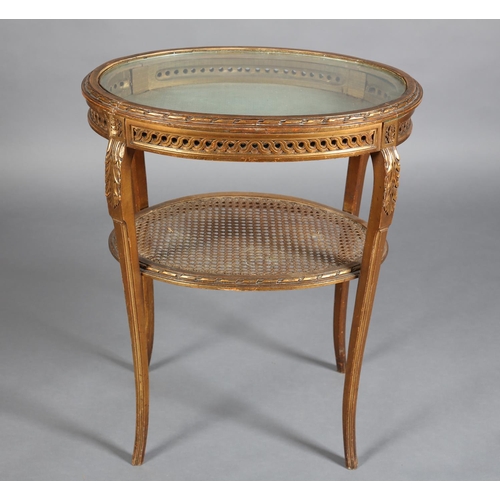 358 - A FRENCH GILTWOOD BIJOUTERIE TABLE, oval, the lift off glazed top with gilt metal beading and carved... 