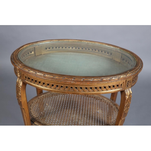 358 - A FRENCH GILTWOOD BIJOUTERIE TABLE, oval, the lift off glazed top with gilt metal beading and carved... 