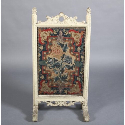 369 - A VICTORIAN CREAM PAINTED FIRE SCREEN with arched and pierced cresting carved with 'C' scrolls and l... 