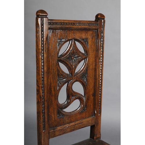 386 - A LATE 19TH CENTURY ELM HALL CHAIR, the panel back pierced with diamond and triform motifs, gauge-cu... 