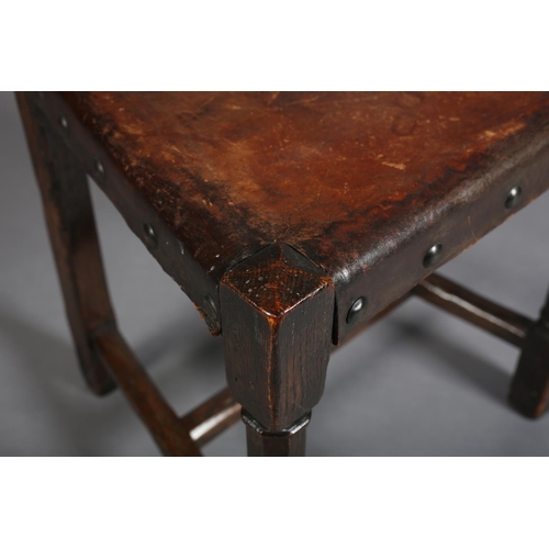 386 - A LATE 19TH CENTURY ELM HALL CHAIR, the panel back pierced with diamond and triform motifs, gauge-cu... 